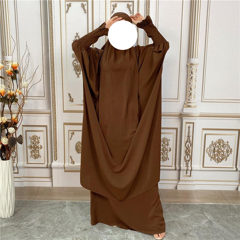 
                      
                        a woman in a brown dress covering her face
                      
                    